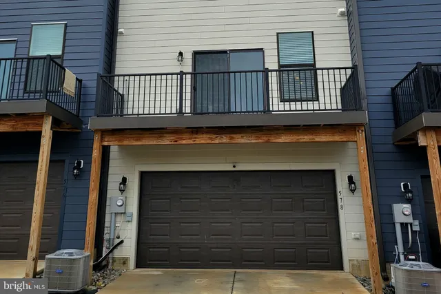 a view of house with deck and a front door