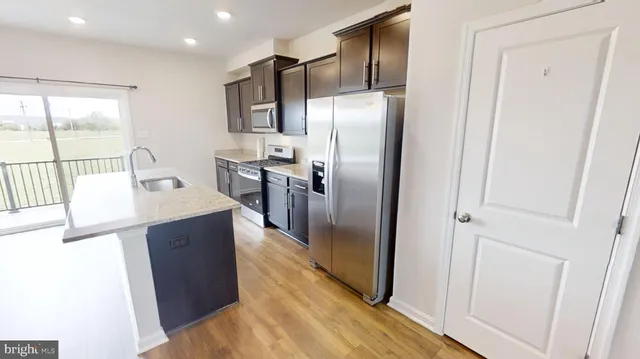 a kitchen with stainless steel appliances a refrigerator and a sink