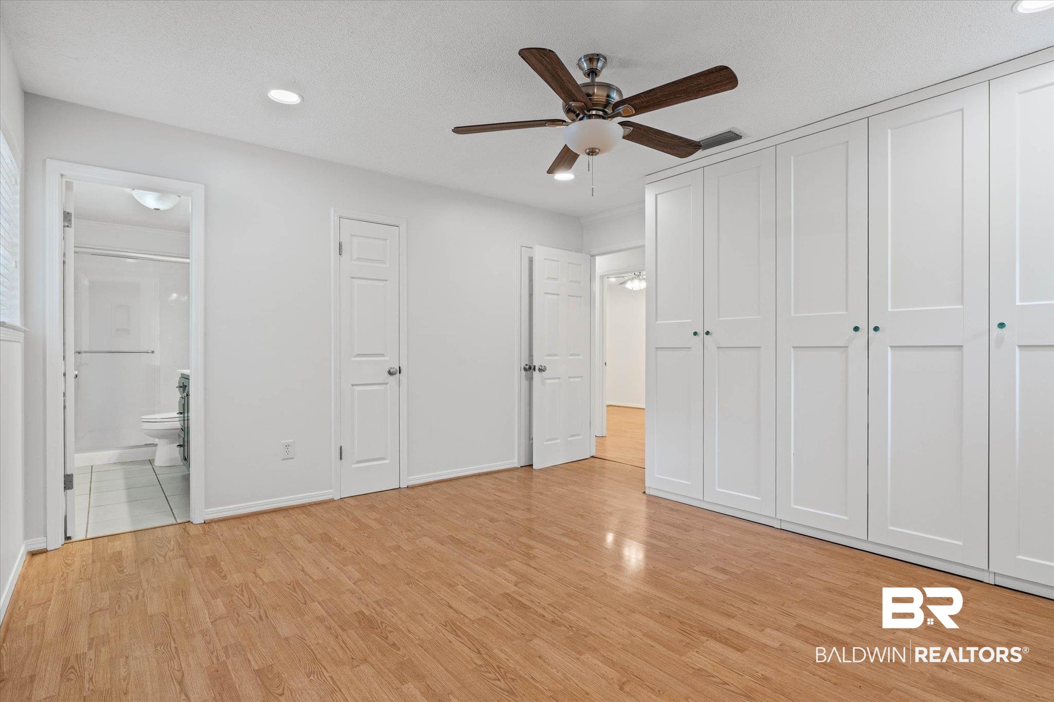 8301 Fordham Road Mobile, AL 36619 - Photo 14 of 57 Spacious room featuring wood-finish flooring, a built-in wardrobe with panel doors, recessed lighting, and a ceiling fan