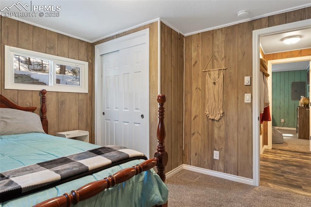 6230 Waterfall Loop Manitou Springs, CO 80829 - Photo 16 of 22 a bedroom with a bed and a walk in closet