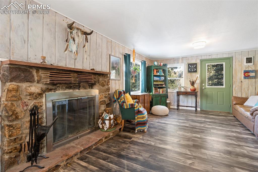 6230 Waterfall Loop Manitou Springs, CO 80829 - Photo 6 of 22 a living room with furniture a fireplace and a window