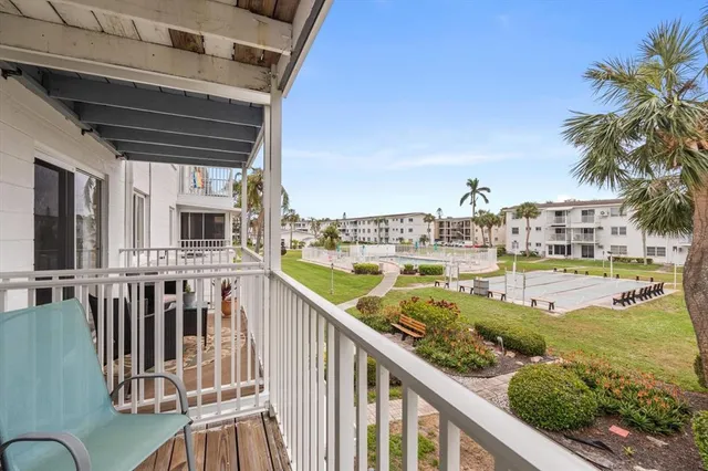 a view of a balcony with lake view and wooden floor
