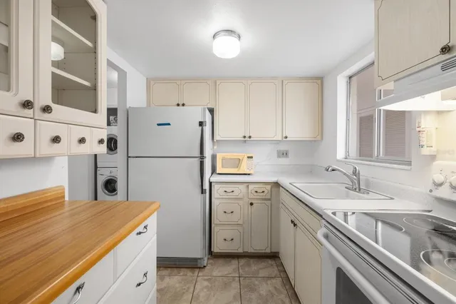a kitchen with a sink stove and refrigerator