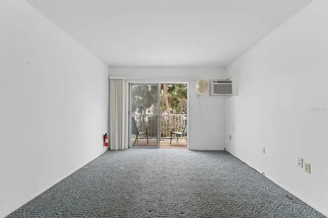 an empty room with windows and entrance