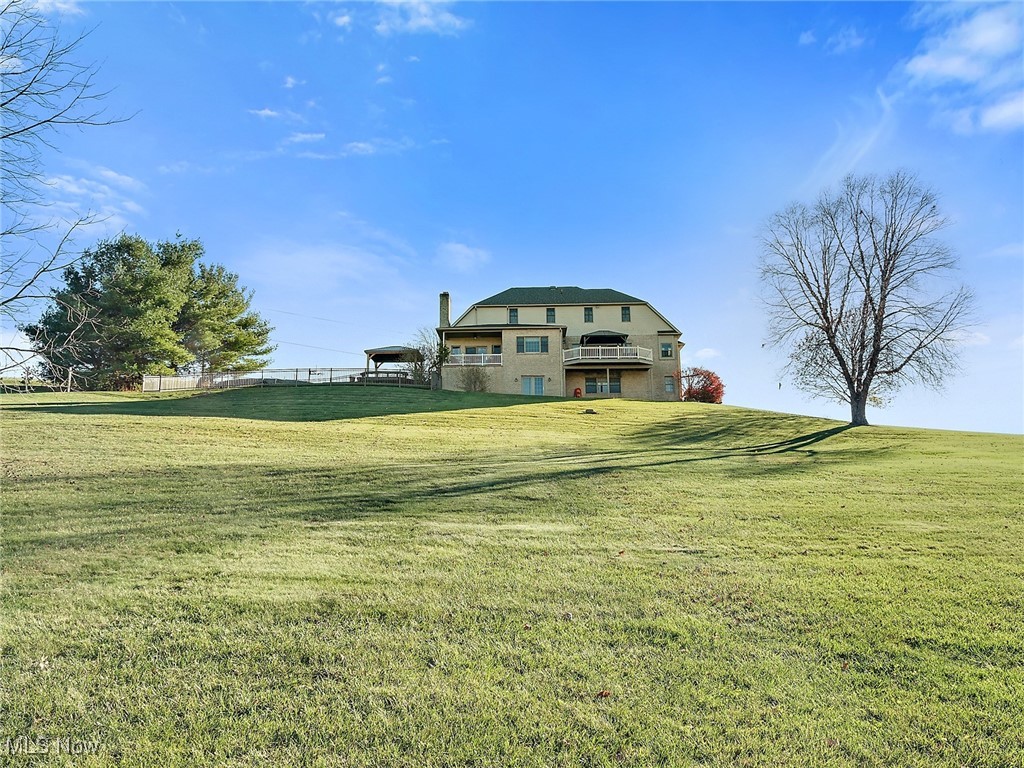 9659 Yoder Road Southwest Sugarcreek, OH 44681 - Photo 29 of 39 View of yard featuring a balcony