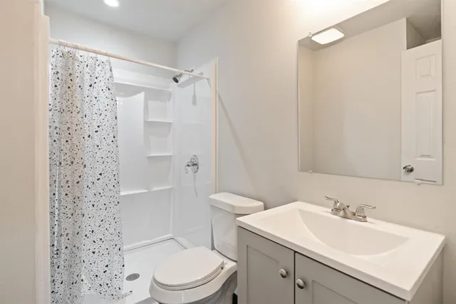 a bathroom with a sink toilet and shower