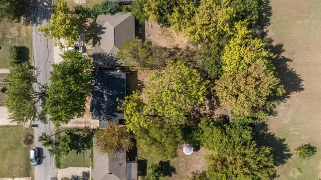an aerial view of a house with yard