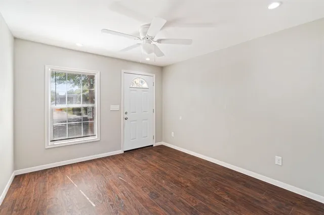 wooden floor in an empty room with a window
