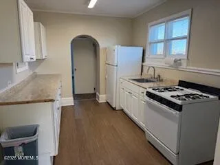a kitchen with granite countertop a stove and a refrigerator