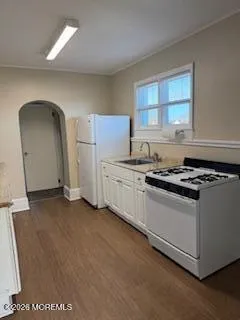 a kitchen with stainless steel appliances granite countertop a sink and a stove