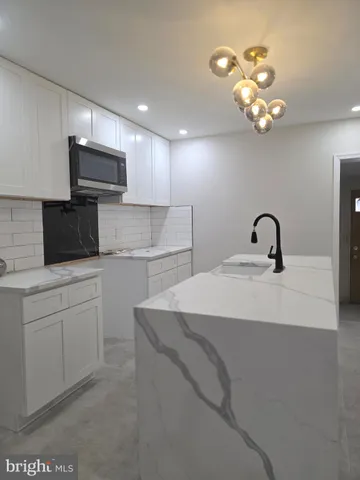 a kitchen with a sink stainless steel appliances and cabinets