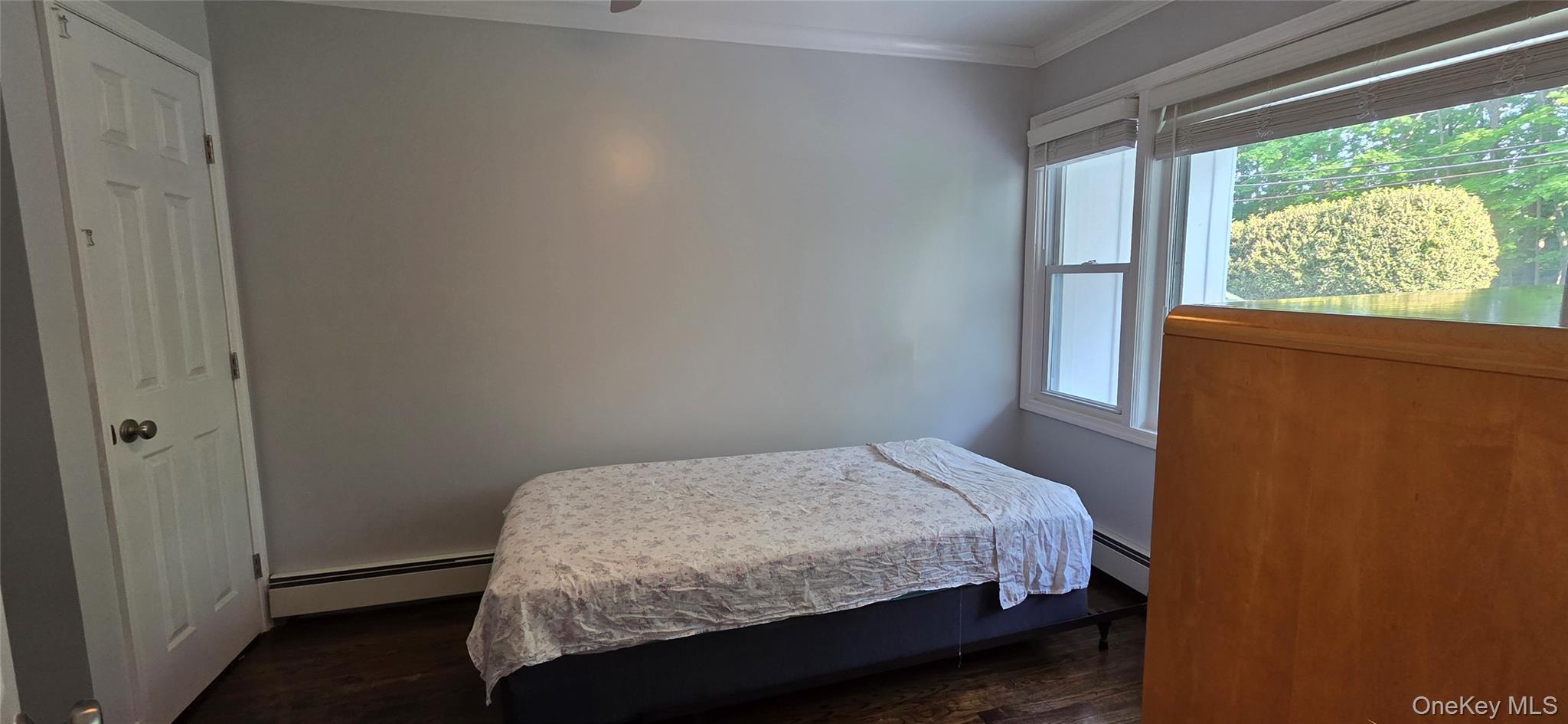 522 Moriches Road St. James, NY 11780 - Photo 19 of 49 a bedroom with a bed and a window
