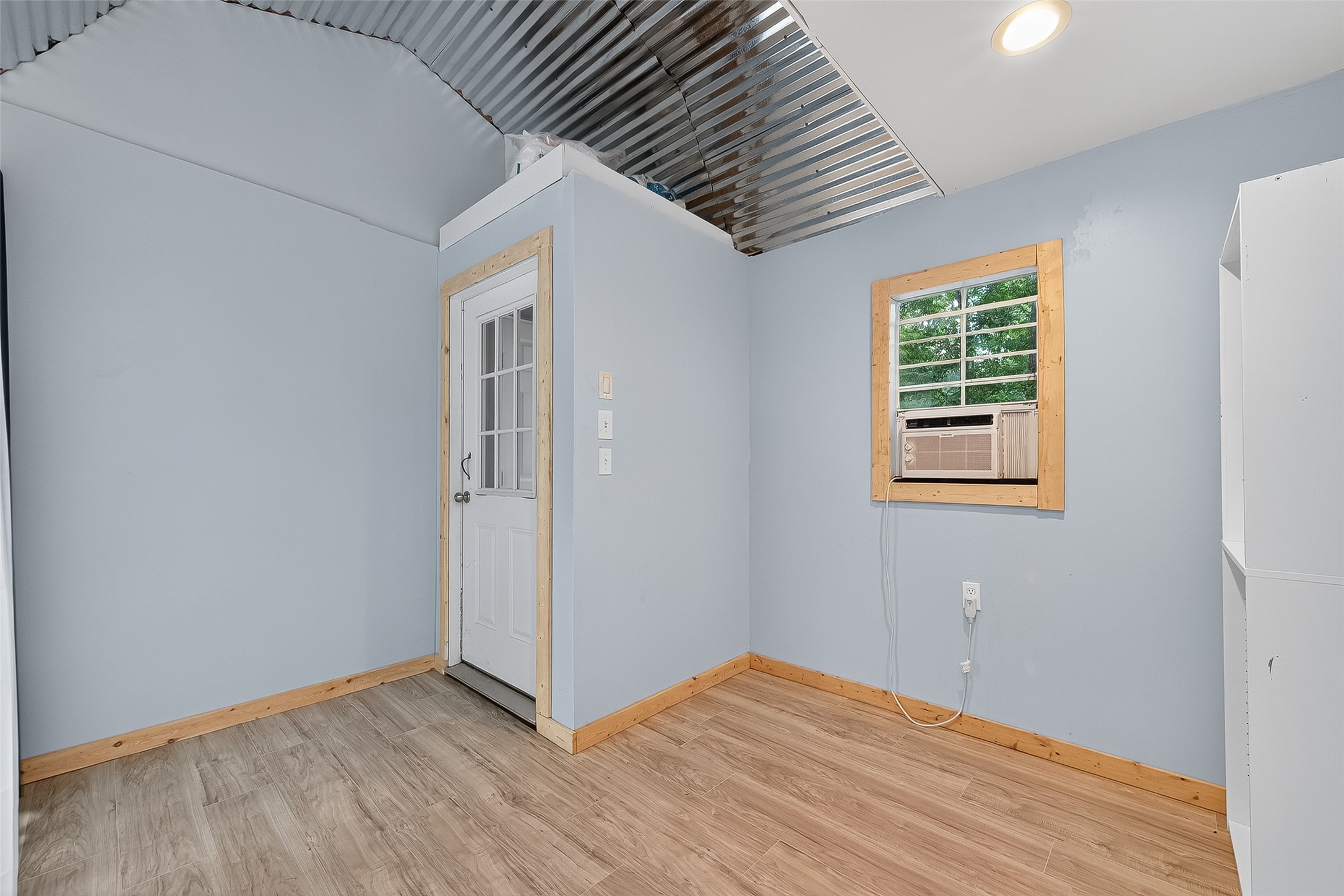 200 Our Road Shepherd, TX 77371 - Photo 19 of 46 an empty room with wooden floor and windows