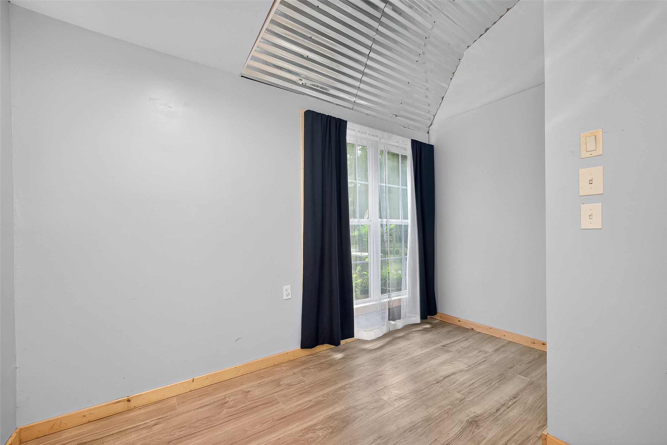 200 Our Road Shepherd, TX 77371 - Photo 20 of 46 a view of an empty room with wooden floor and a window