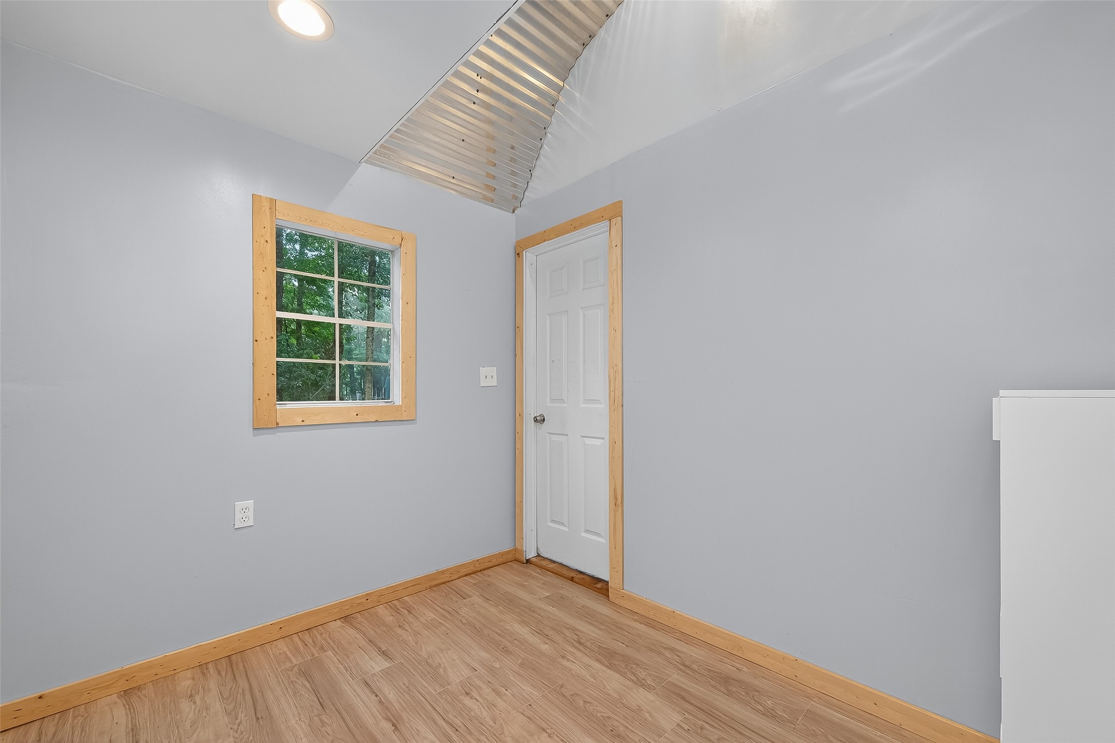 200 Our Road Shepherd, TX 77371 - Photo 21 of 46 an empty room with wooden floor and windows