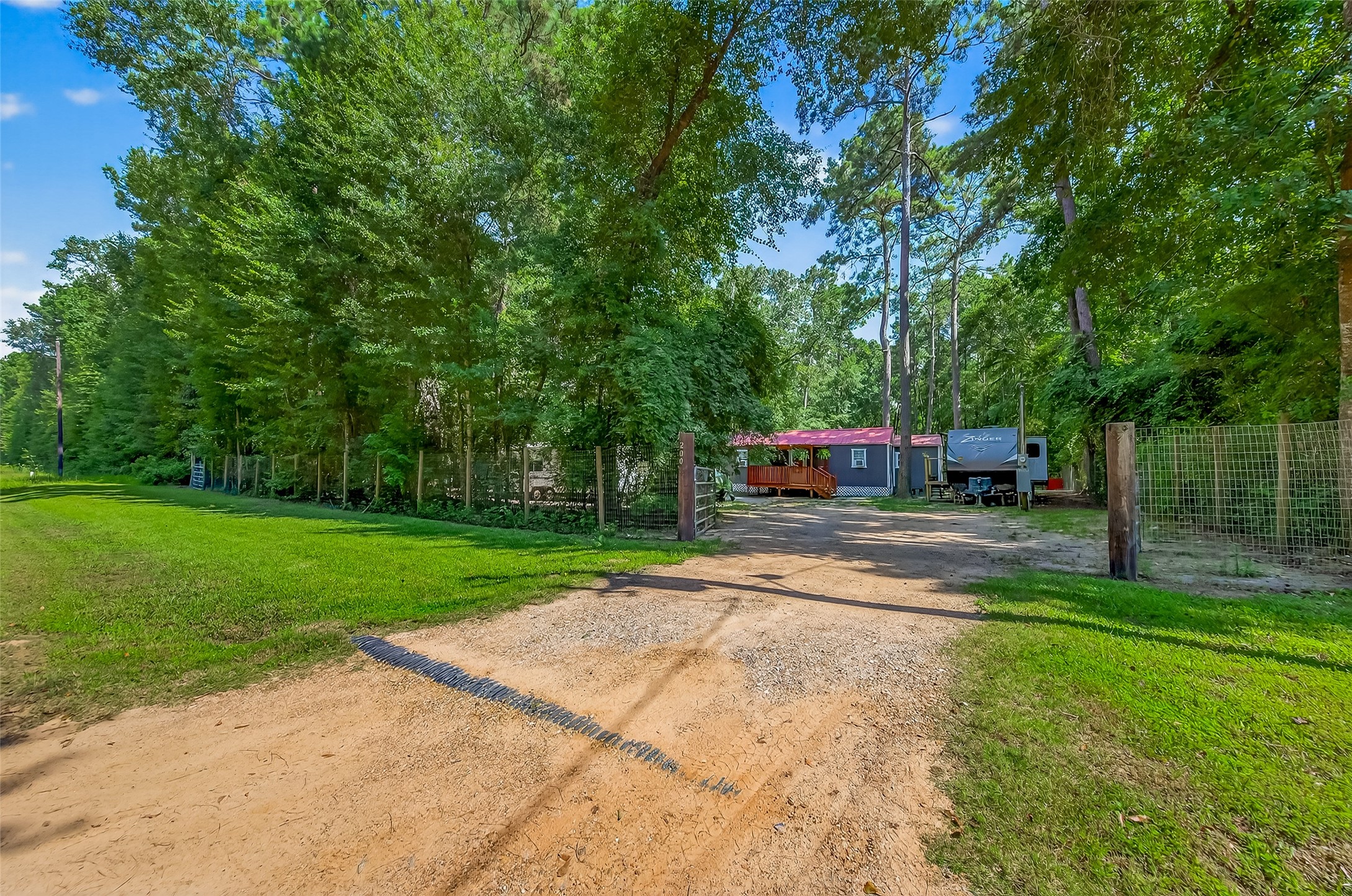 200 Our Road Shepherd, TX 77371 - Photo 23 of 46 a view of street with tall trees and a big yard