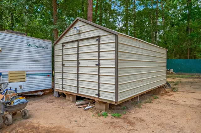 a backyard of a house with barbeque oven and yard