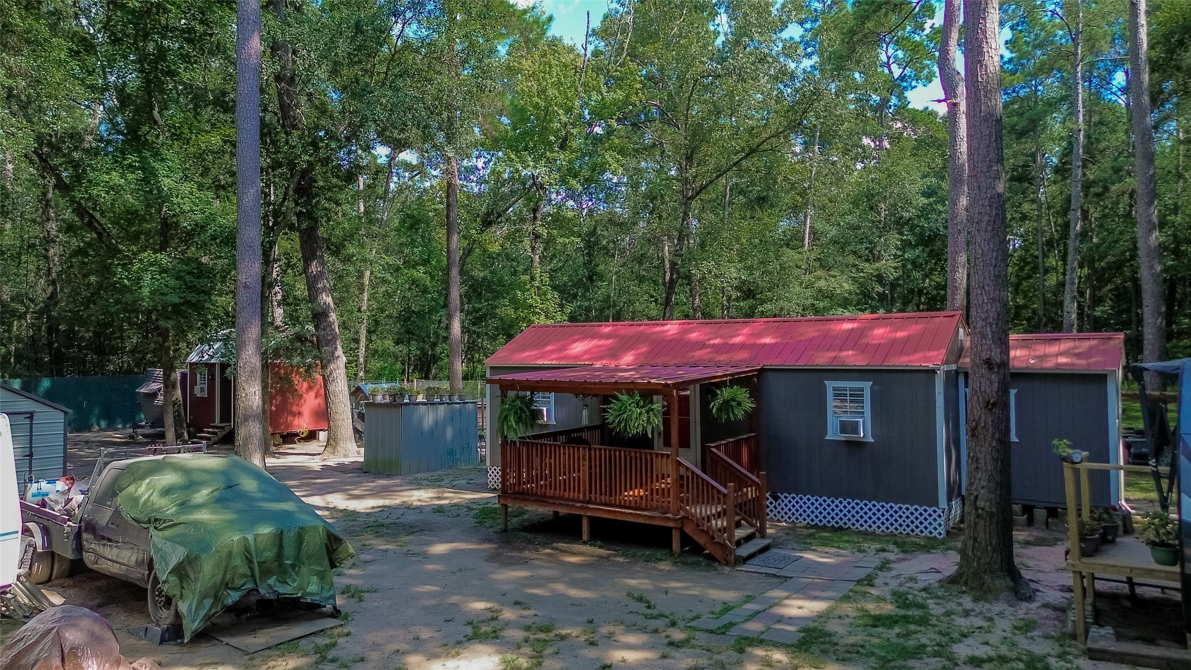 200 Our Road Shepherd, TX 77371 - Photo 40 of 46 an outdoor sitting area with furniture and umbrella