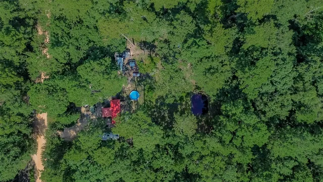 a view of a lake with a yard and mountain view in back