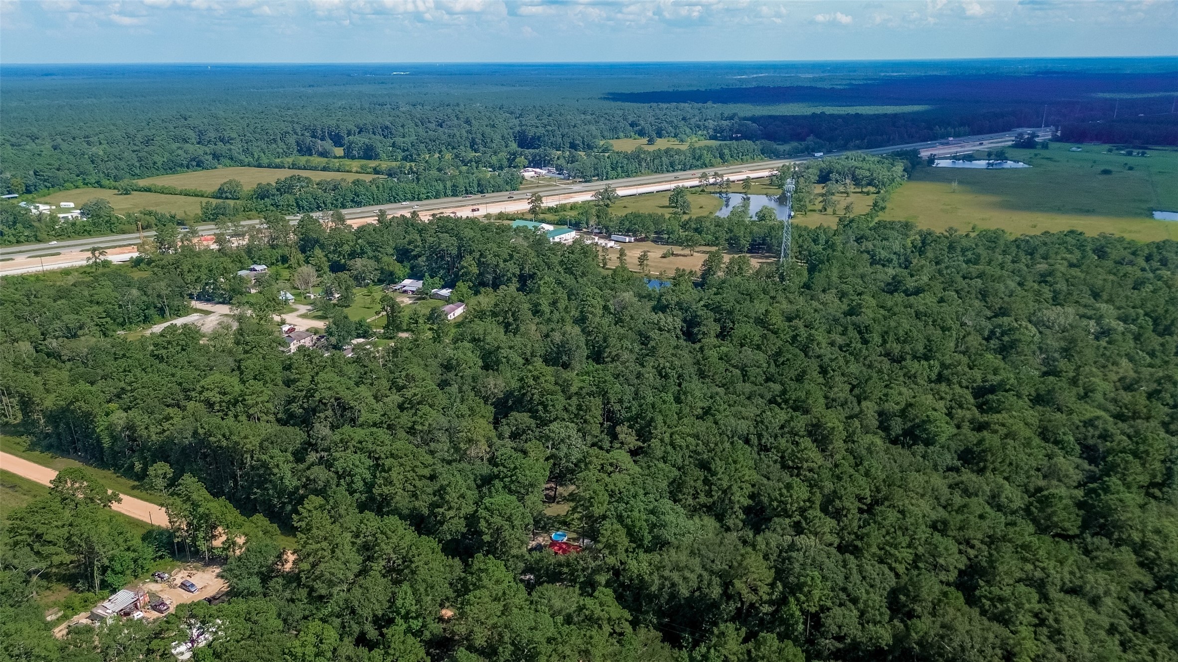 200 Our Road Shepherd, TX 77371 - Photo 43 of 46 a view of a lake with a yard and mountain view in back