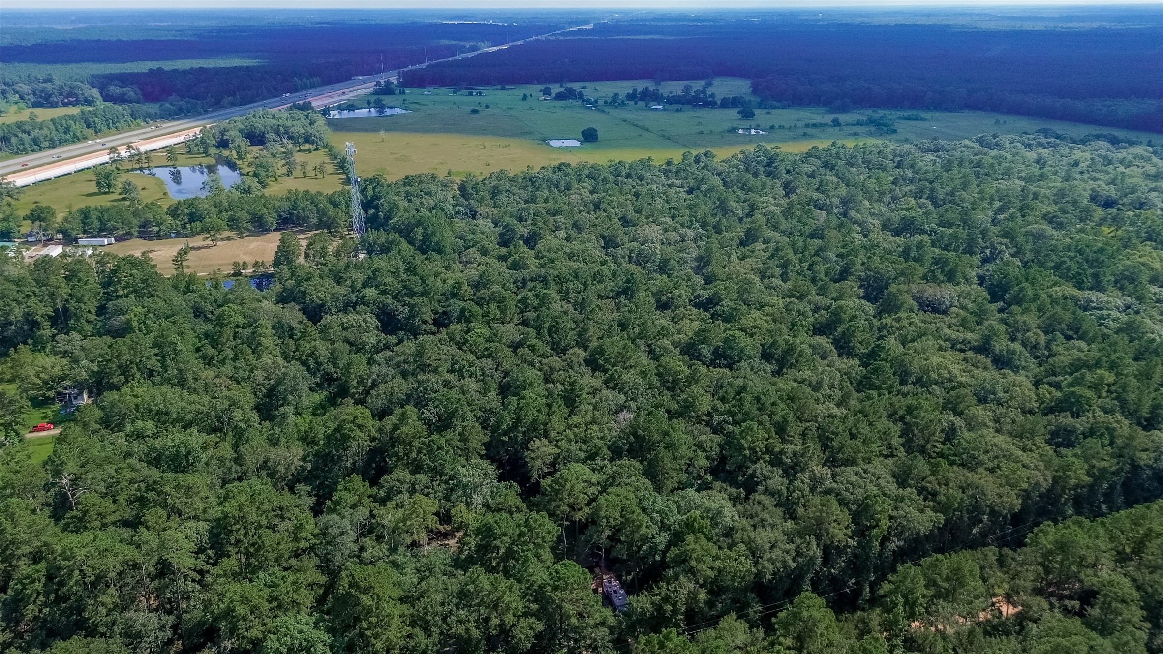 200 Our Road Shepherd, TX 77371 - Photo 45 of 46 an aerial view of a houses with a lush green forest