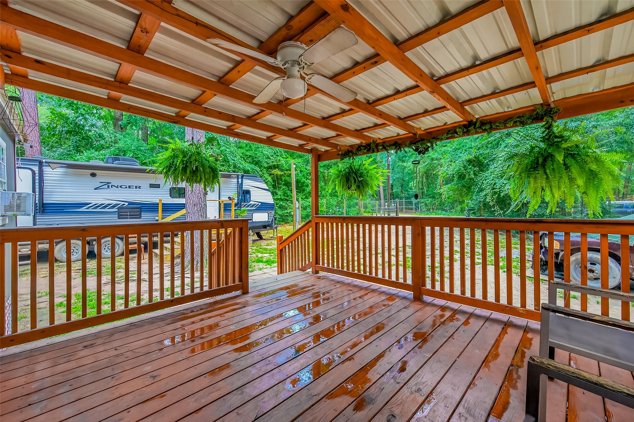 200 Our Road Shepherd, TX 77371 - Photo 5 of 46 a balcony with wooden floor in outdoor space