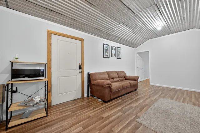 a spacious bedroom with a bed and a dresser