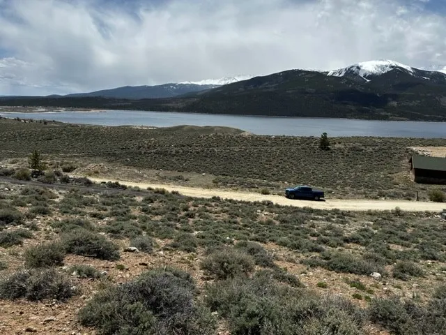 a view of a lake in middle of a field