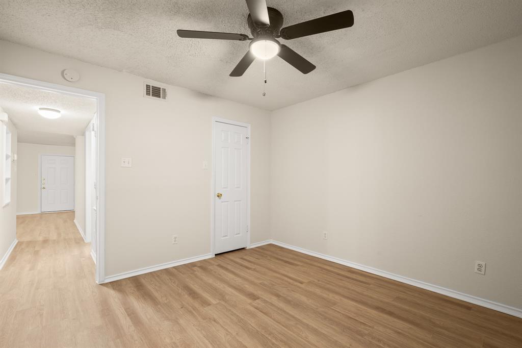 2401 Leon Street, Unit 105 Austin, TX 78705 - Photo 11 of 18 an empty room with wooden floor and ceiling fan