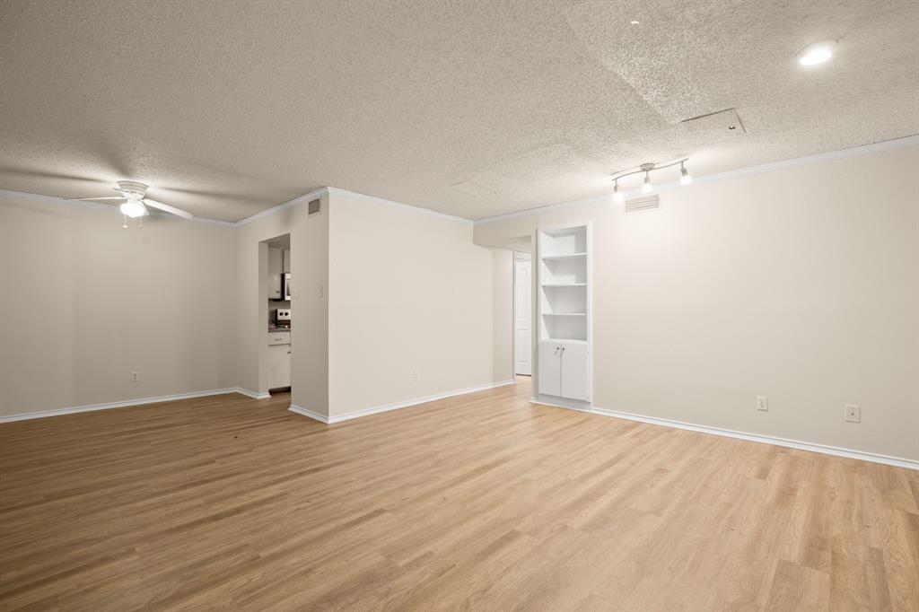 2401 Leon Street, Unit 105 Austin, TX 78705 - Photo 4 of 18 a view of an empty room with wooden floor