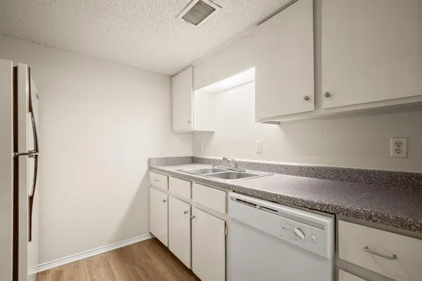 a kitchen with a sink and cabinets
