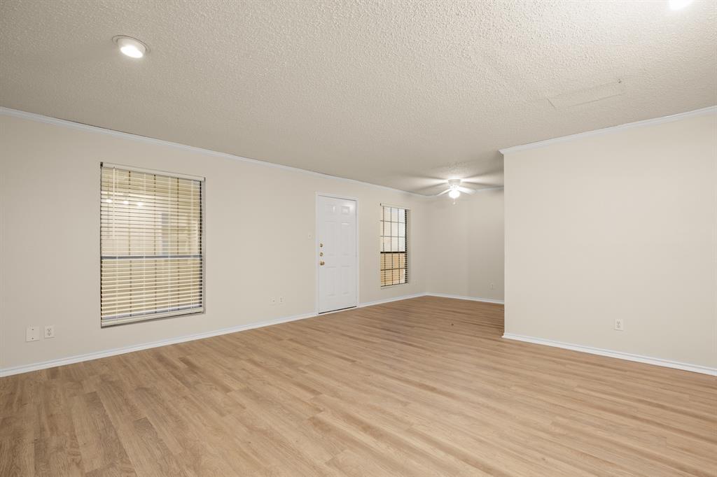 2401 Leon Street, Unit 105 Austin, TX 78705 - Photo 7 of 18 an empty room with wooden floor and windows
