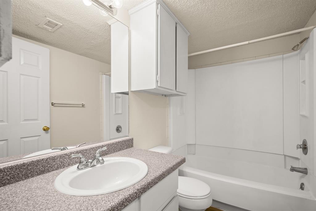 2401 Leon Street, Unit 105 Austin, TX 78705 - Photo 9 of 18 a bathroom with a sink toilet and shower