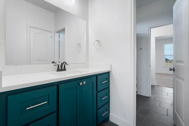 a bathroom with a sink toilet a mirror and shower