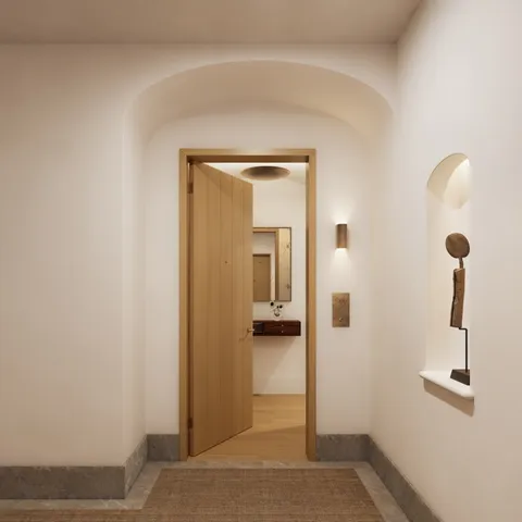 a view of a hallway with wooden floor and closet