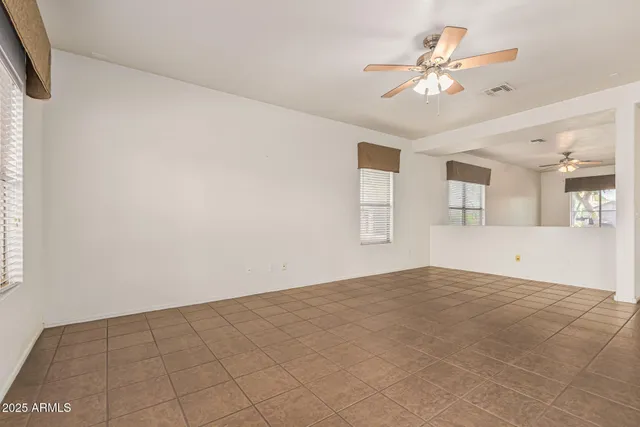 a view of a big room with closet and windows