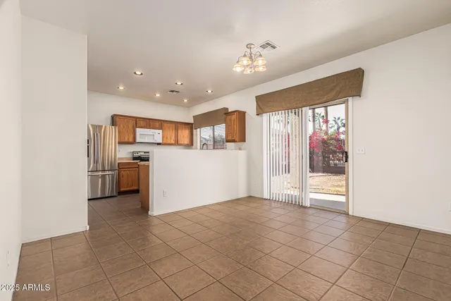 a kitchen with granite countertop a sink stainless steel appliances and window