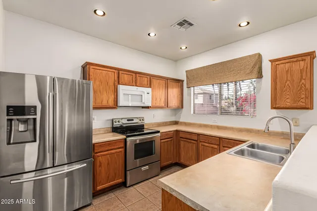 a kitchen with a sink stove top oven and cabinets