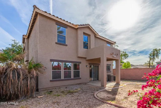 a view of a house with a backyard