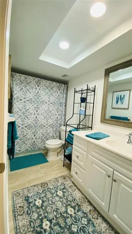 a bathroom with a sink toilet and window