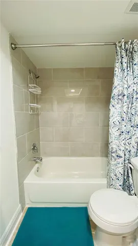 a bathroom with a bathtub and shower