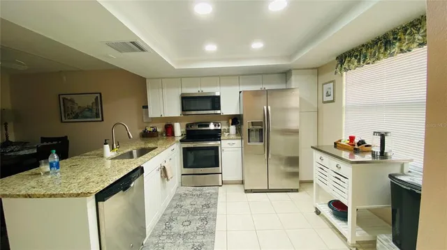 a kitchen with a sink stove and refrigerator