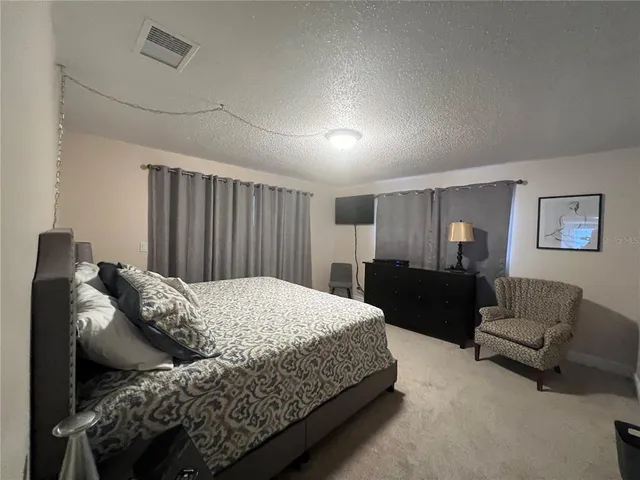 a bedroom with a bed and a couch