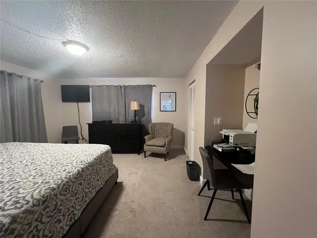 a bedroom with a bed and a furniture