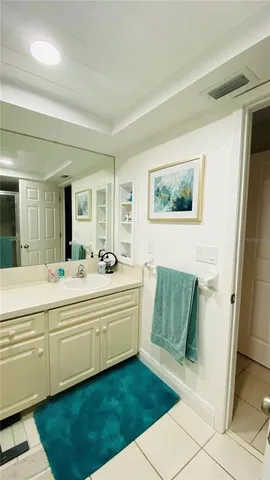 a bathroom with a sink mirror and a bath tub