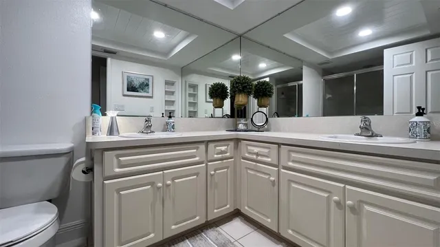 a bathroom with a sink double vanity and a toilet