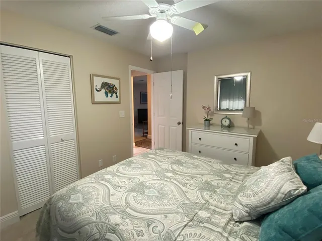 a bedroom with a large bed and a chandelier