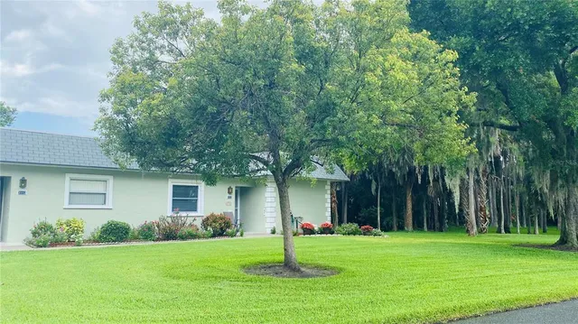 a house with a big yard and large trees