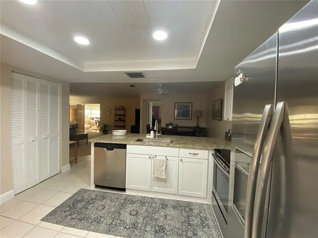 a kitchen with a sink stainless steel appliances and cabinets