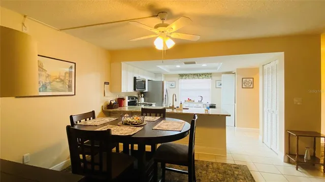 a view of a dining room with furniture and a chandelier